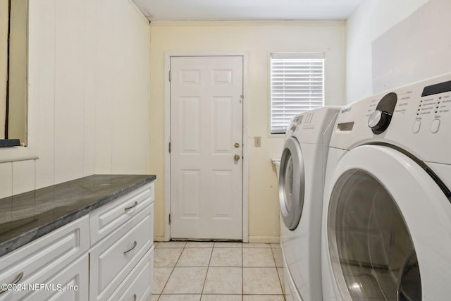 washroom featuring crown molding, independent washer and dryer, cabinets, and light tile patterned floors