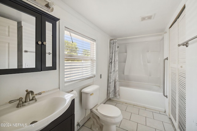 bathroom featuring toilet, vanity, visible vents, tile patterned floors, and shower / bath combo with shower curtain