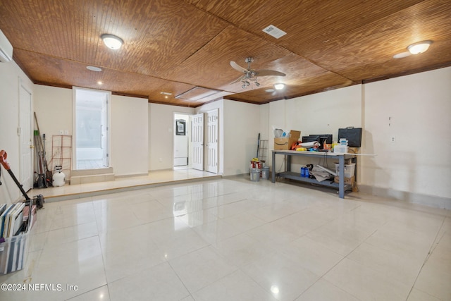 basement with wooden ceiling, ceiling fan, and light tile patterned flooring