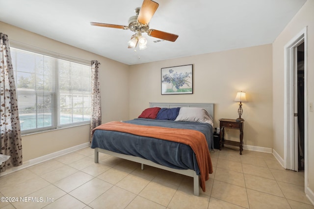 bedroom featuring ceiling fan, visible vents, baseboards, and light tile patterned flooring