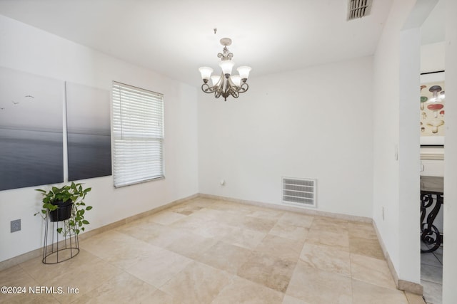 unfurnished room featuring visible vents, baseboards, and an inviting chandelier