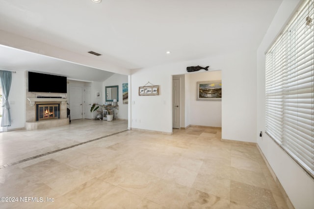 unfurnished living room with lofted ceiling