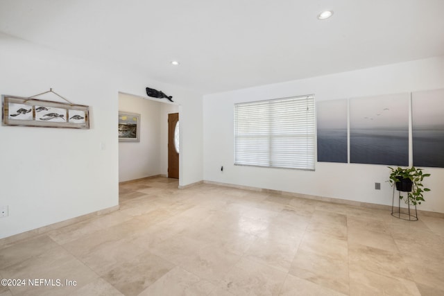 spare room with baseboards and recessed lighting