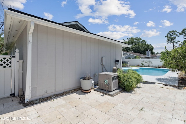 view of side of property with a fenced in pool and a patio