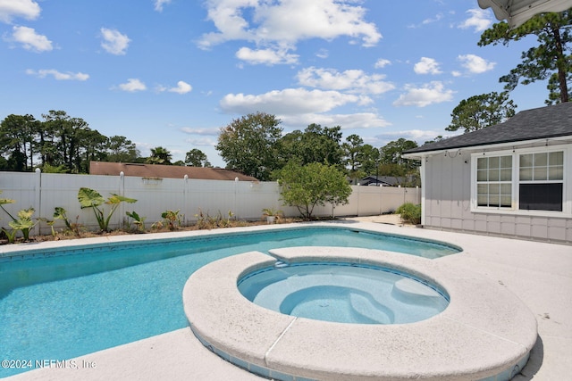 view of swimming pool featuring a fenced in pool, a fenced backyard, and an in ground hot tub