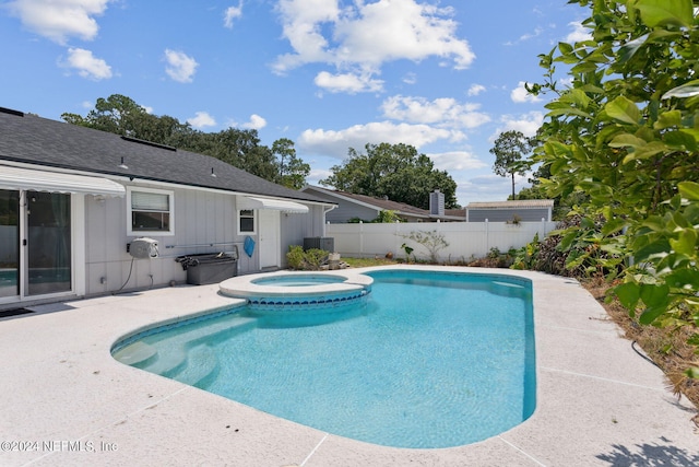 view of pool featuring a patio and an in ground hot tub