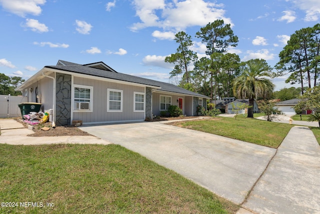 ranch-style home with fence and a front lawn