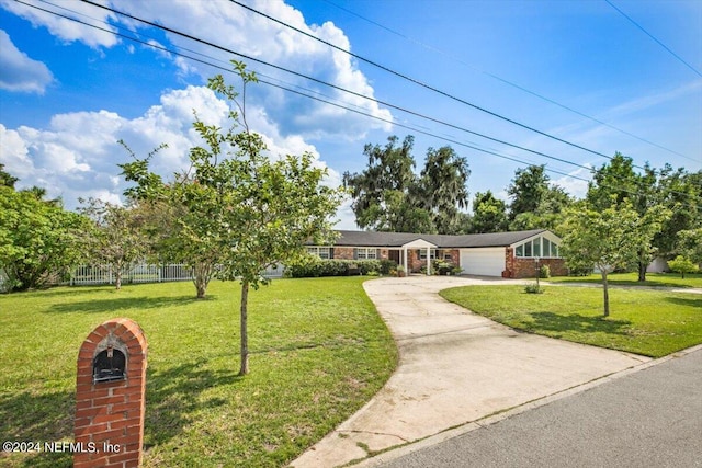 view of front of home with a garage and a front yard