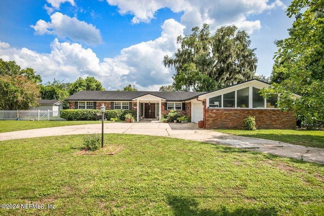 ranch-style home with a garage and a front yard