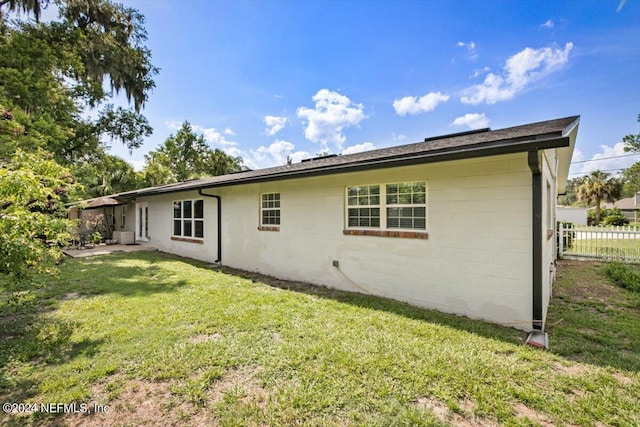 rear view of property with a yard