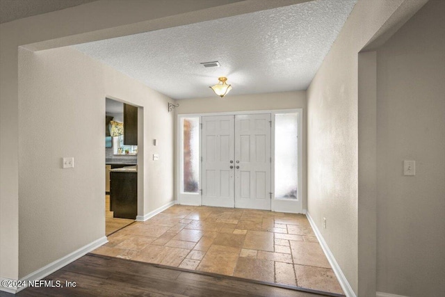 foyer featuring a textured ceiling