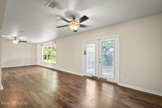 spare room with french doors, ceiling fan, dark hardwood / wood-style flooring, and a textured ceiling