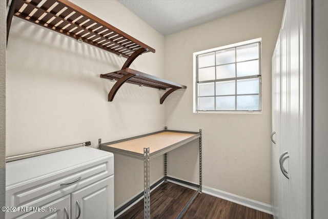 laundry room featuring dark hardwood / wood-style flooring and a textured ceiling