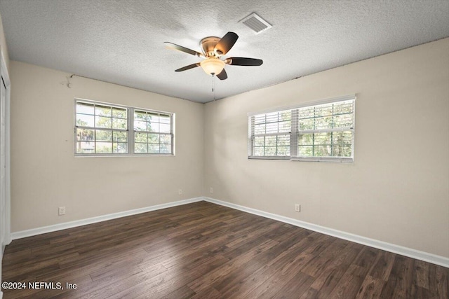 unfurnished room with dark wood-type flooring, ceiling fan, and a textured ceiling