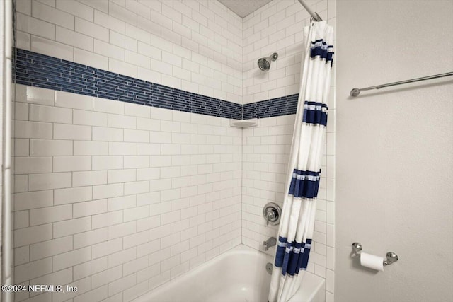 bathroom featuring shower / tub combo with curtain