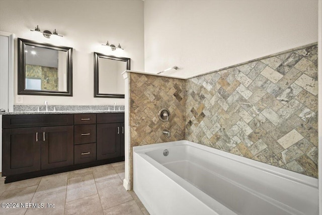 bathroom featuring vanity, tile patterned flooring, and a bathtub