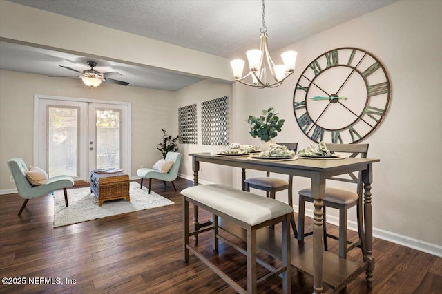 dining room featuring ceiling fan with notable chandelier, a textured ceiling, dark hardwood / wood-style flooring, and french doors