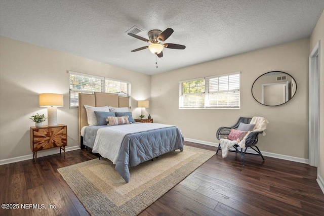 bedroom featuring multiple windows, a textured ceiling, dark hardwood / wood-style flooring, and ceiling fan