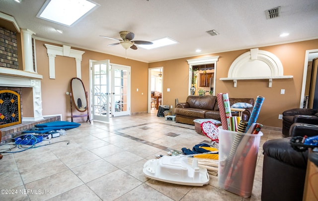 living room with light tile patterned floors, a textured ceiling, ceiling fan, and french doors