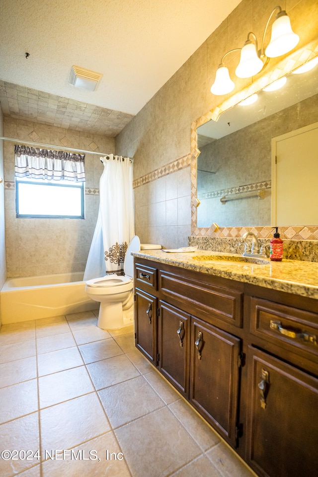 full bathroom featuring tile walls, tile patterned flooring, shower / bathtub combination with curtain, toilet, and vanity