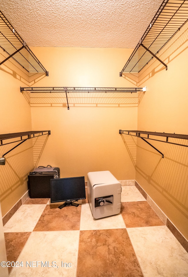 spacious closet featuring tile patterned flooring