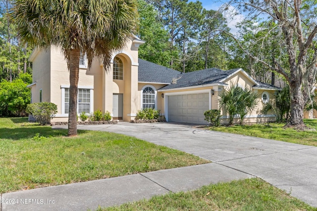 mediterranean / spanish-style house with a garage and a front yard