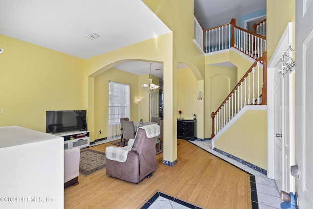 living room with hardwood / wood-style flooring and a notable chandelier