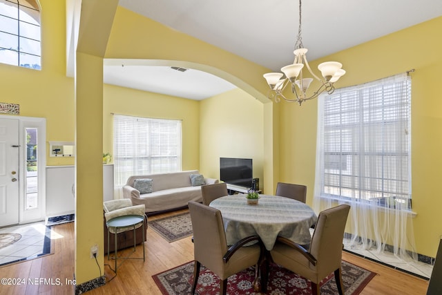 dining area featuring a chandelier and light wood-type flooring