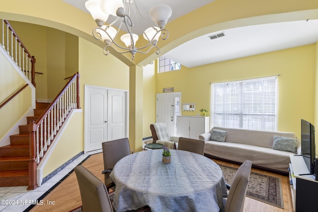 dining space with a chandelier and light hardwood / wood-style floors