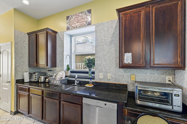 kitchen with tasteful backsplash, light tile patterned floors, stainless steel dishwasher, and sink