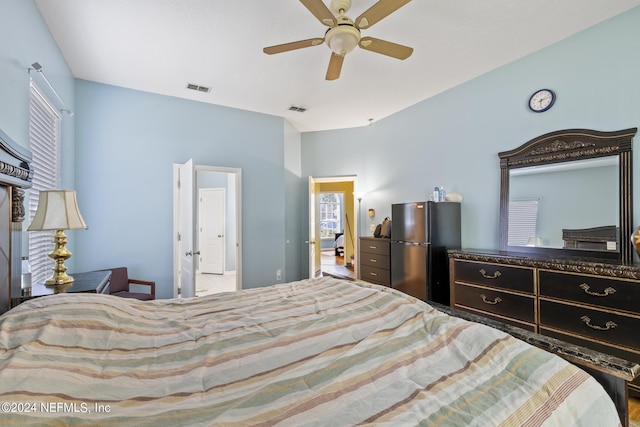 bedroom with ceiling fan and refrigerator