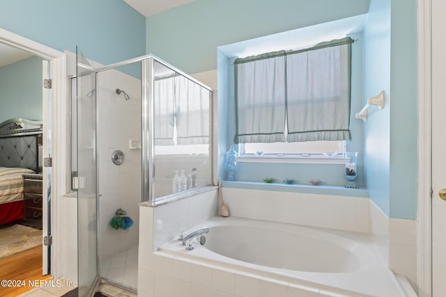 bathroom with shower with separate bathtub