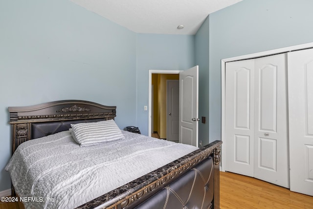 bedroom featuring light wood-type flooring and a closet