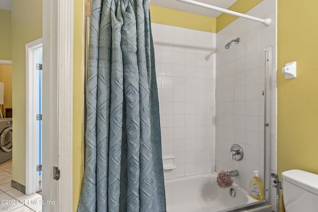 bathroom featuring washer / clothes dryer, tile patterned flooring, shower / bath combination with curtain, and toilet