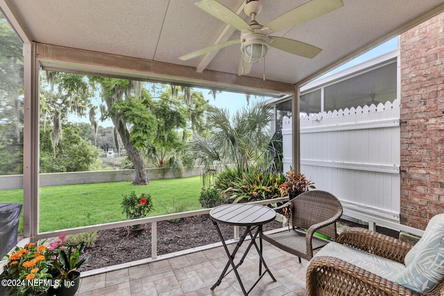 sunroom / solarium featuring ceiling fan and a healthy amount of sunlight