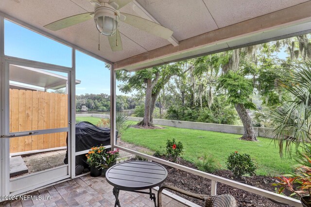 sunroom featuring ceiling fan