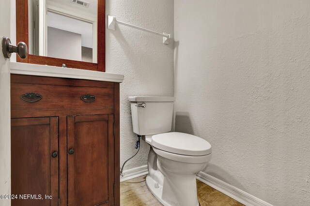 bathroom with tile patterned flooring, toilet, and vanity