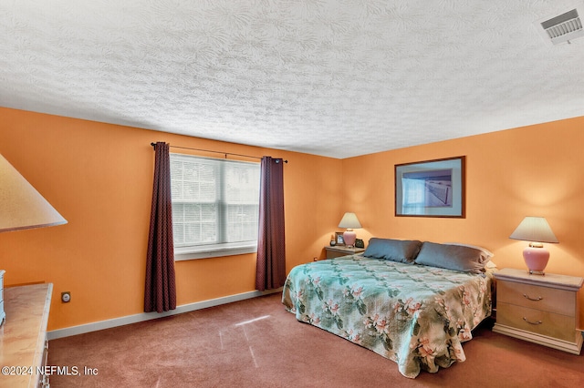 bedroom featuring carpet floors and a textured ceiling