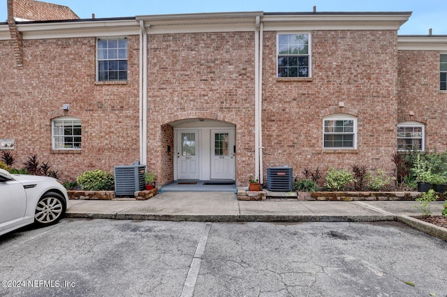 view of front of house with french doors and central air condition unit