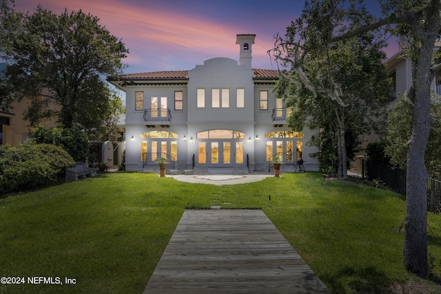 24554 Harbour View Dr, Ponte Vedra Beach, FL 32082 - back of house with french doors, a balcony, a lawn, and a tiled roof