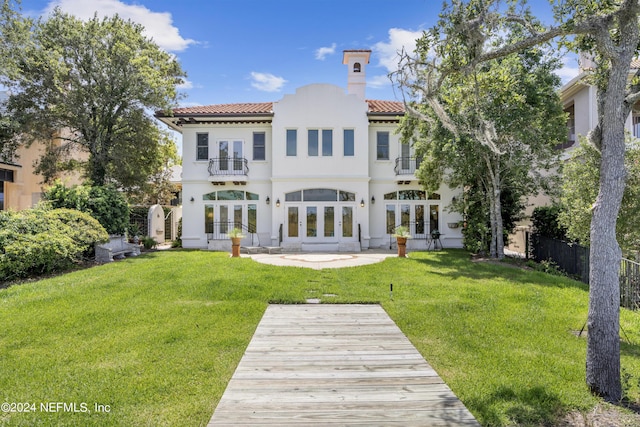 24554 Harbour View Dr, Ponte Vedra Beach, FL 32082 - back of property with french doors, a balcony, a tile roof, a chimney, and stucco siding
