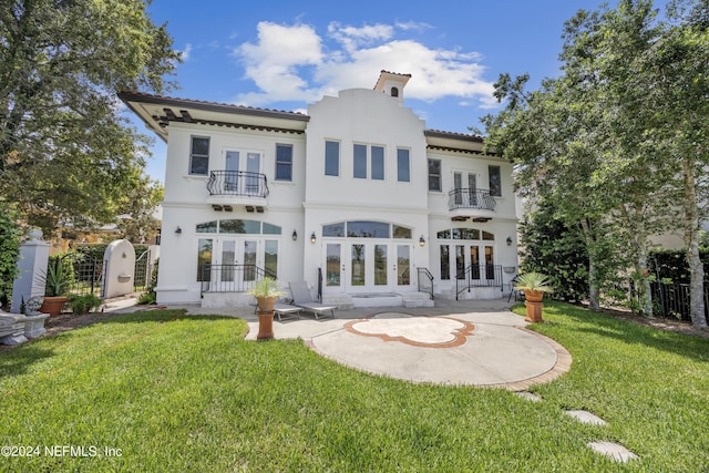 24554 Harbour View Dr, Ponte Vedra Beach, FL 32082 - rear view of house with french doors, a balcony, stucco siding, a patio area, and a tiled roof