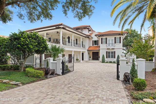 24554 Harbour View Dr, Ponte Vedra Beach, FL 32082 - mediterranean / spanish home with a balcony, a gate, decorative driveway, a tiled roof, and a garage