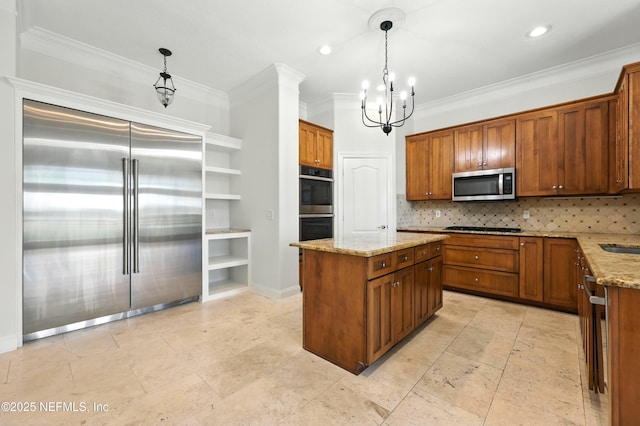 24554 Harbour View Dr, Ponte Vedra Beach, FL 32082 - kitchen featuring appliances with stainless steel finishes, crown molding, a chandelier, light stone counters, and brown cabinetry