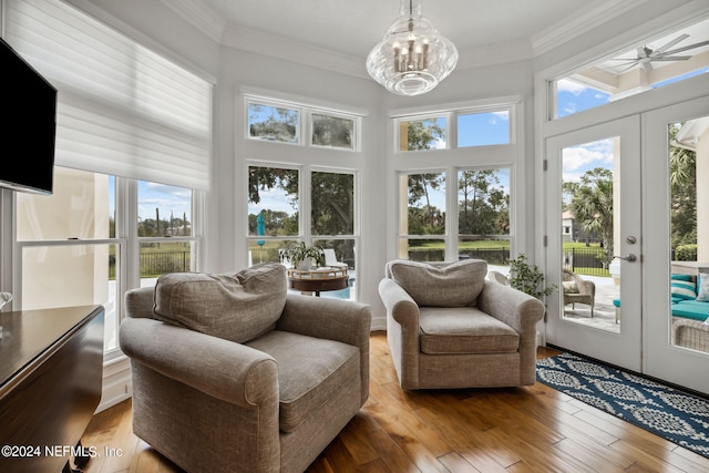 sunroom with french doors and an inviting chandelier