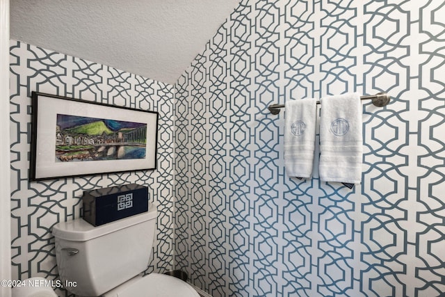 bathroom with a textured ceiling and toilet