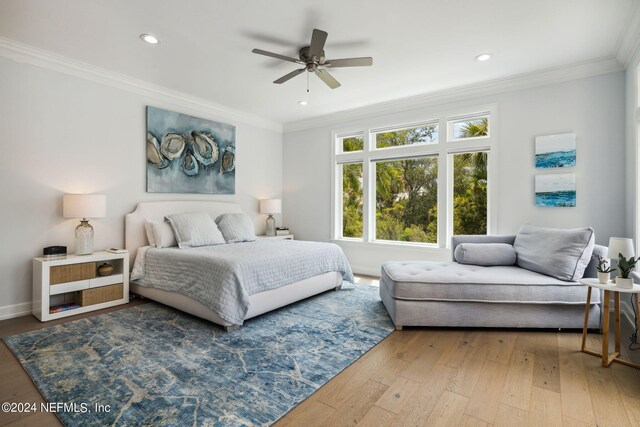 bedroom with wood-type flooring, ornamental molding, and ceiling fan