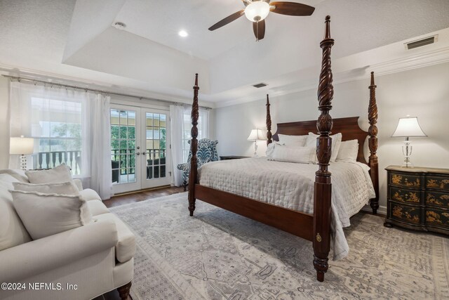 bedroom with access to exterior, crown molding, a raised ceiling, and french doors