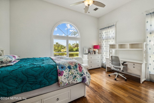 bedroom with ceiling fan and dark hardwood / wood-style flooring