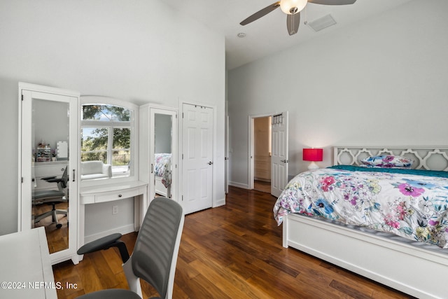 bedroom with ceiling fan, high vaulted ceiling, and dark hardwood / wood-style flooring